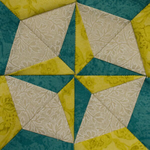 Compass Rose Miniature Block size 3in pieced with teal and yellow points on a cream background fabric