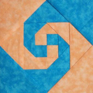 Snail's Trail block image with blue and orange fabric