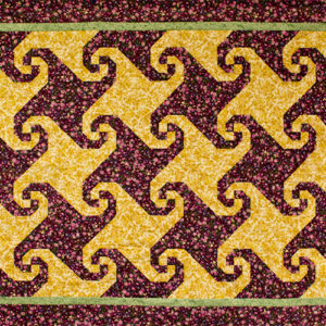 Snail's Trail quilt top image in purple and yellow fabric