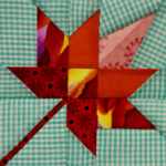 Snail's Trail Miniature Block size 3in pieced with shades of red and gingham fabrics